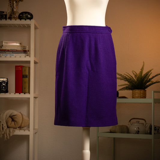 Archival Christian Lacroix Paris 90s Electric Purple Wool Pencil Skirt – vibrant electric purple bouclé wool, structured waistband with self-fabric button tab, front pleat detail, knee-length pencil silhouette, minimalist couture aesthetic, product shot on dress form