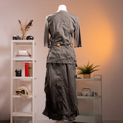 back view Archive Cop Copine "Pontivy" 90s French Avant-Garde Utility Gown – gunmetal grey cotton taffeta maxi dress with asymmetric square neckline, three-quarter sleeves with button detail, trompe l'oeil layered cargo pocket skirt with drawstring ruching, original amber resin belt, ruffled hem, product shot on dress form