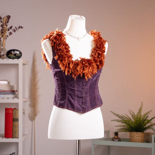 Front view of the archival mid-90s Lolita Lempicka paneled corset top on a museum mannequin, highlighting the sweetheart neckline with tinsel shag fringe.