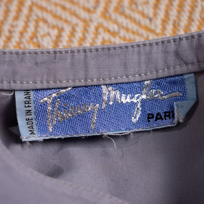 Close-up of the crisp vintage Thierry Mugler Paris woven mainline script inner neck label in vault preservation quality.
