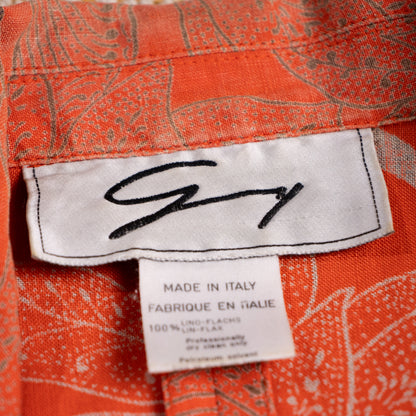 Close-up of the vintage archival Genny woven script neck label representing the Gianni Versace design era with 100 percent Lino-Flachs fabric tag.
