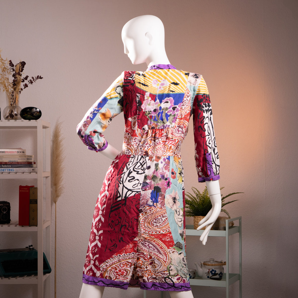 back view Museum Piece Archival Etro Milano S/S 2003 Silk Patchwork Midi Dress – pure silk, maximalist mixed-print patchwork combining crimson Moorish tile motif, abstract face line drawing, watercolour floral, yellow stripe, paisley and blue abstract panels, purple contrast trim at collar, cuffs and hem, hand-blown red glass buttons at placket, gathered empire waist, long sleeves, rare runway archive IT 42, flat lay editorial shot