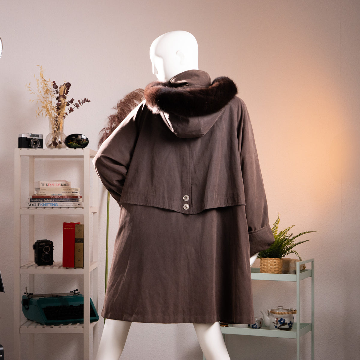 Rear view of the archival Jean-Louis Scherrer coat showing the wide A-line cape silhouette, deep hood, and storm flap details.