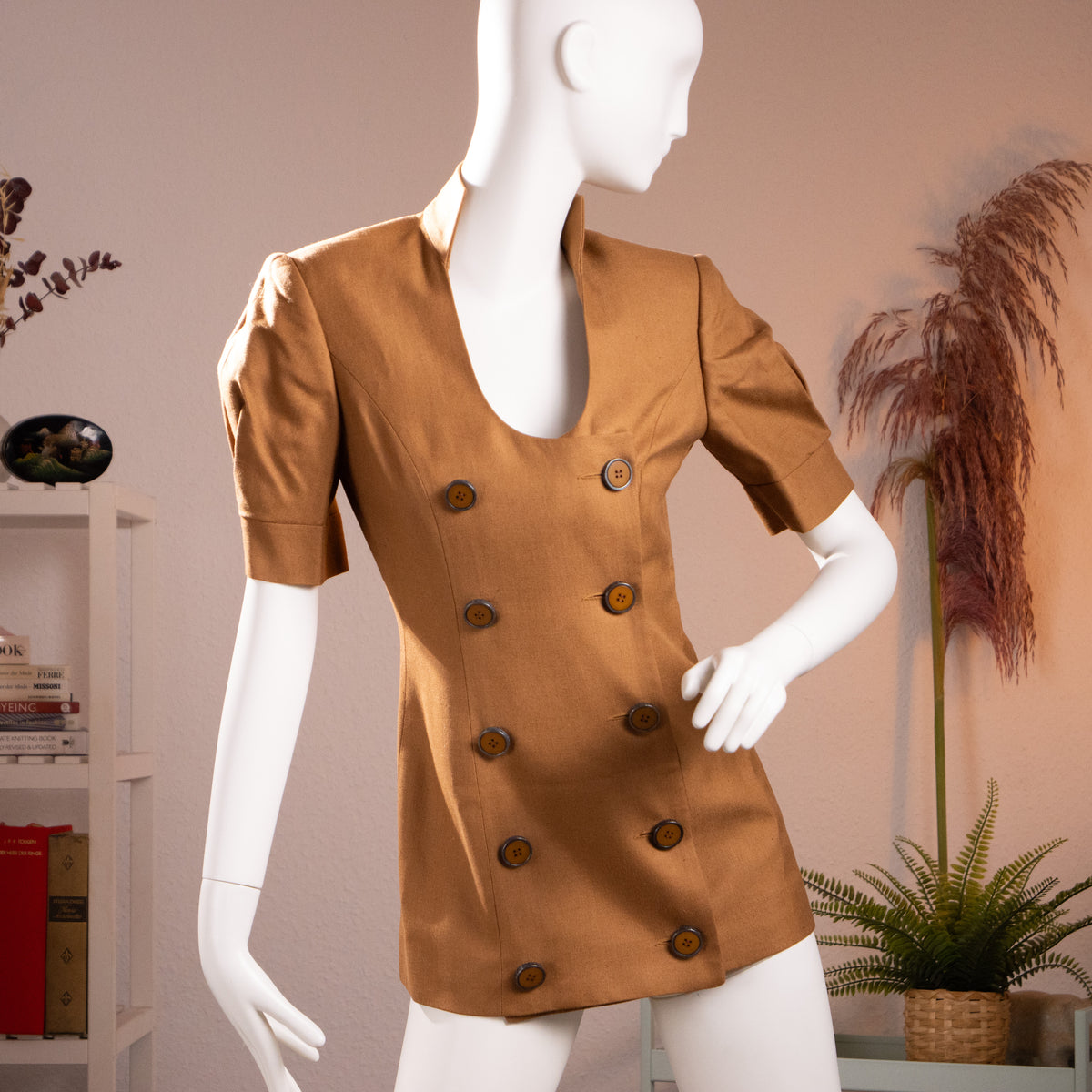 Front view of the archival Jean-Louis Scherrer Couture numbered cognac viscose canvas micro dress on a museum mannequin.