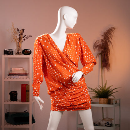 Front view of the archival Emanuel Ungaro Parallèle orange silk polka dot draped wrap dress from the late 1980s on a museum mannequin.