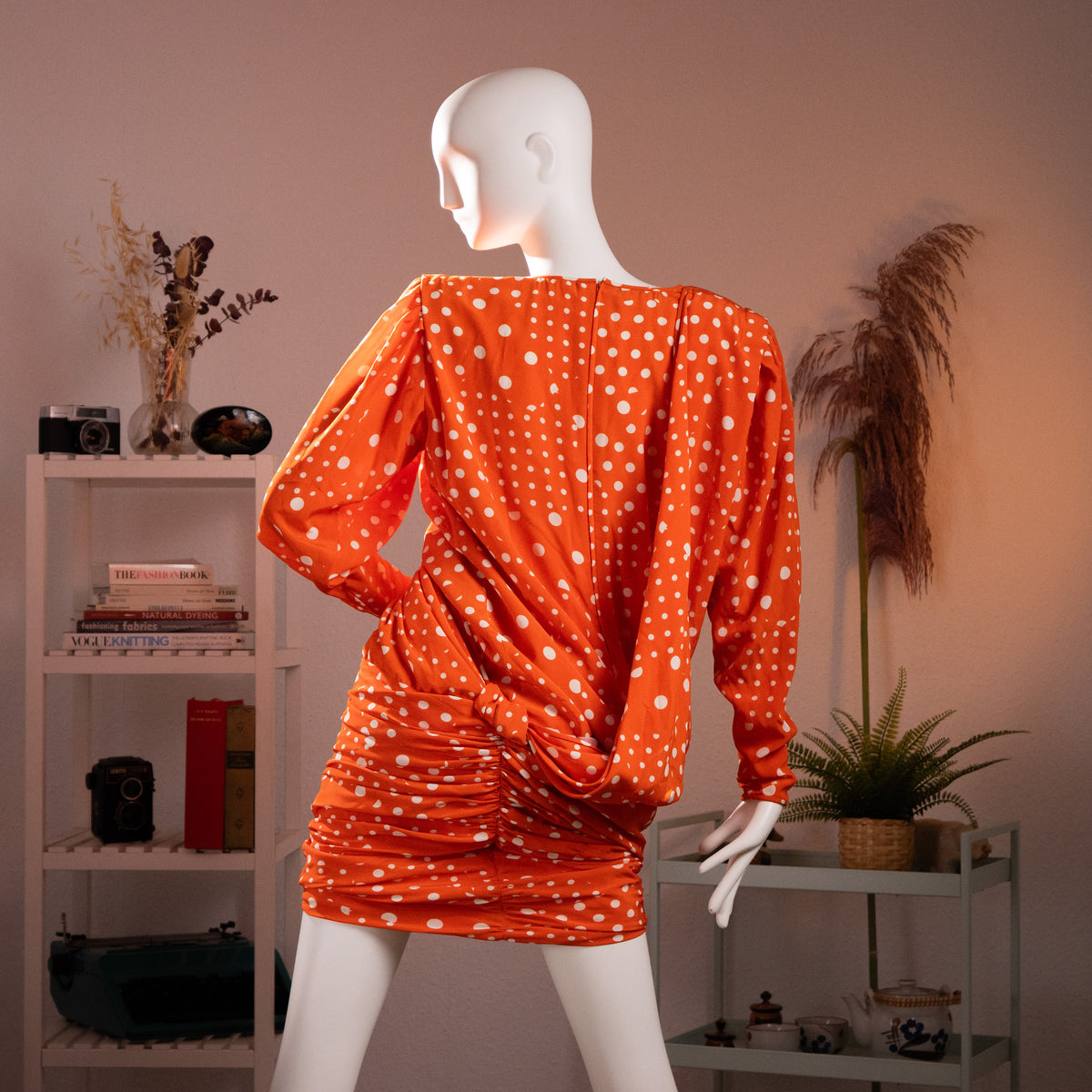 Rear view of the archival Emanuel Ungaro dress showing the deep draped peplum volume, strong padded shoulders, and tightly ruched skirt profile.