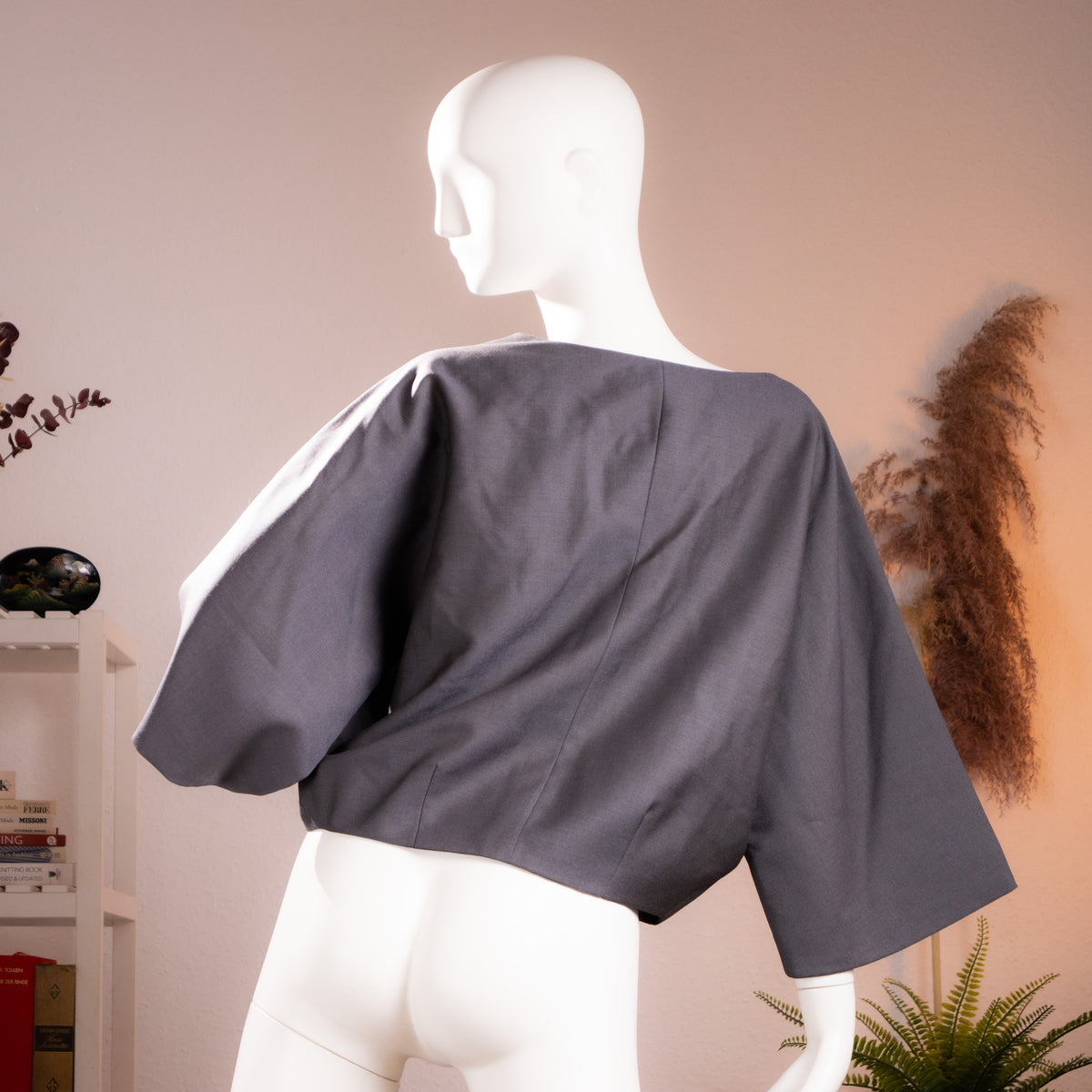 Rear view of the archival Chloé 2007 structural boxy cropped bolero jacket highlighting the wide geometric sleeve silhouette.