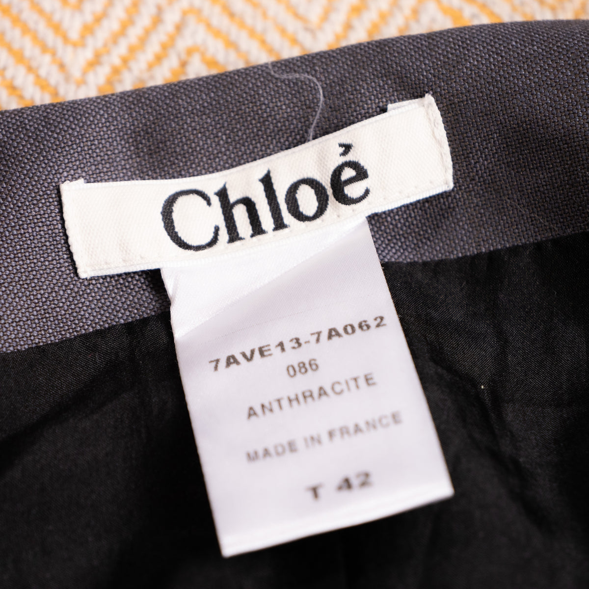 Close-up interior view of the woven white Chloé main label showcasing style code 7AVE13-7A062 and Made in France provenance.