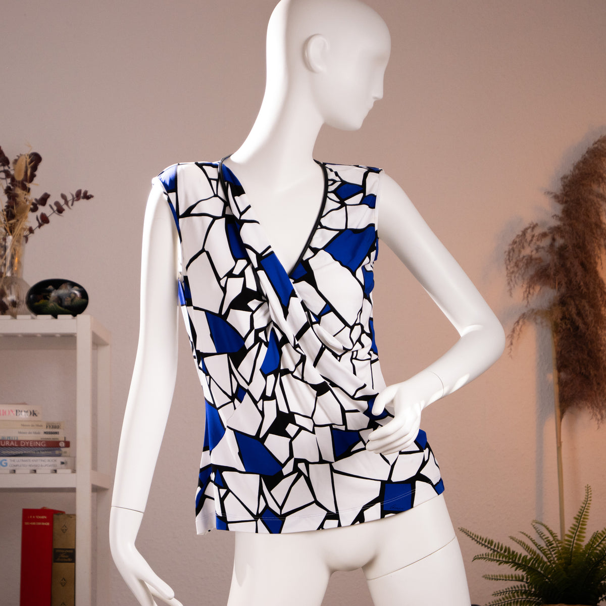 Front view of the archival Frida Giannini for Gucci mosaic abstract print draped viscose tank top with black leather trim on a museum mannequin.