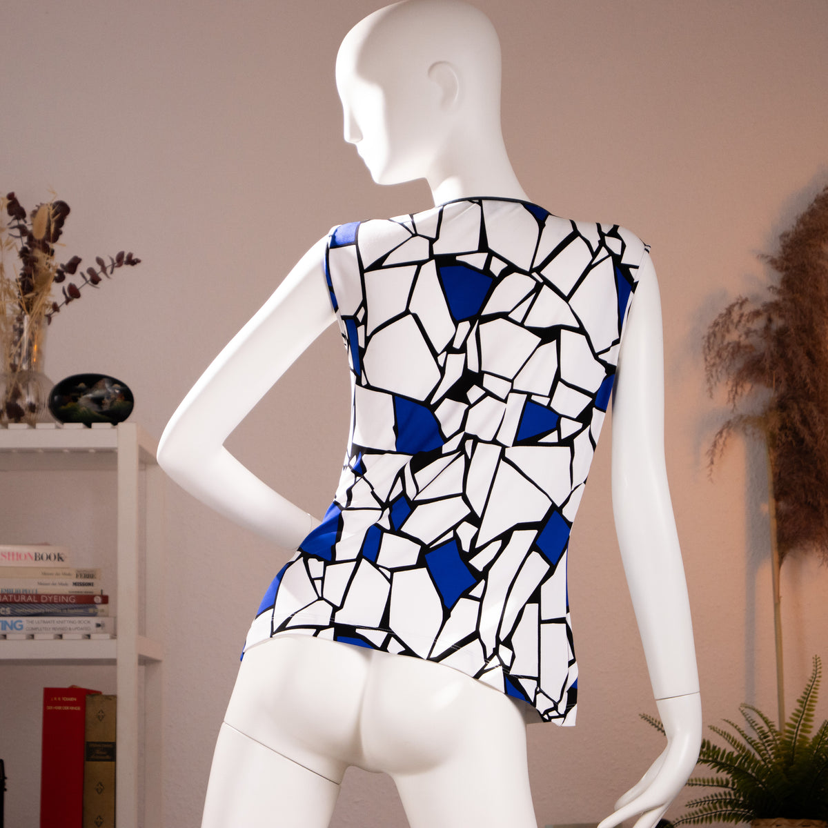 Rear view of the archival Gucci 2009 geometric blue white and black graphic print sleeveless top highlighting the clean tailored back profile.