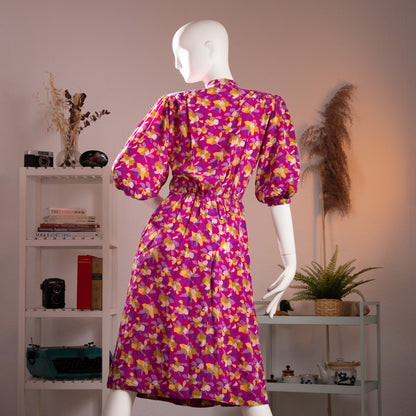 Rear full-length view of the archival Jean-Louis Scherrer Boutique abstract print silk dress highlighting the gathered elastic waist and puff sleeves on a museum mannequin.