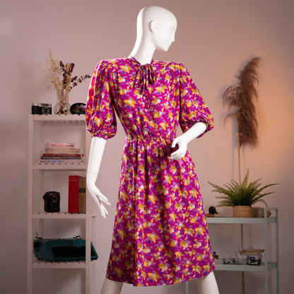 Front full-length view of the archival Scherrer Boutique late 1980s magenta silk dress showcasing the tied pussy-bow neck closure and fluid silhouette.