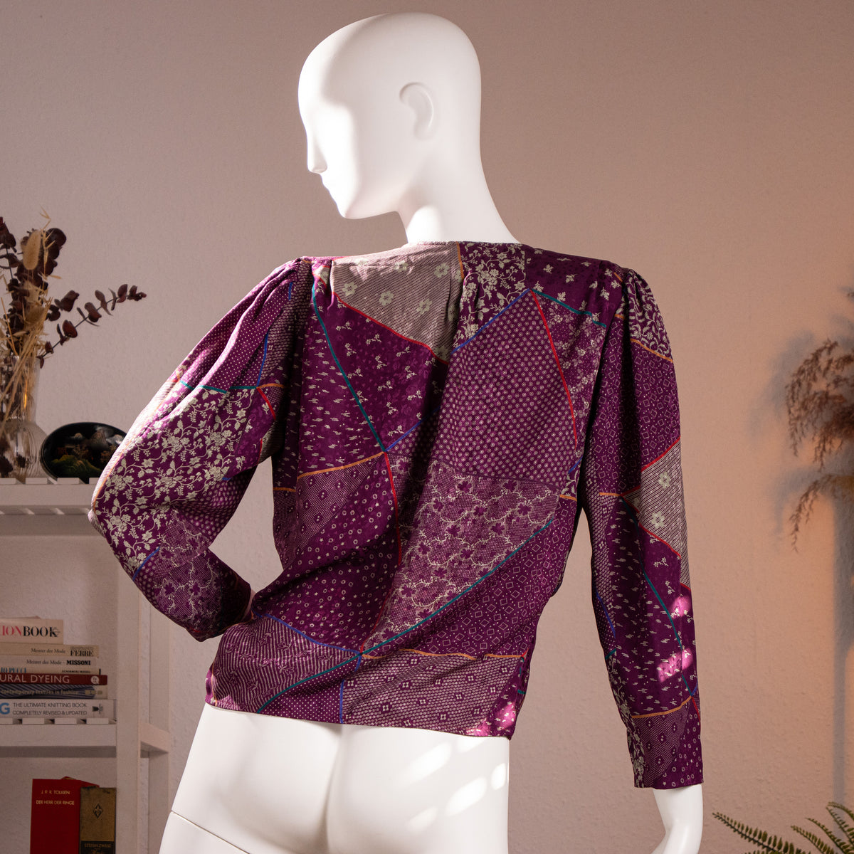 Rear view of the immaculate archival Emanuel Ungaro late 1980s purple silk damask blouse showcasing the seamless geometric patchwork print flow.