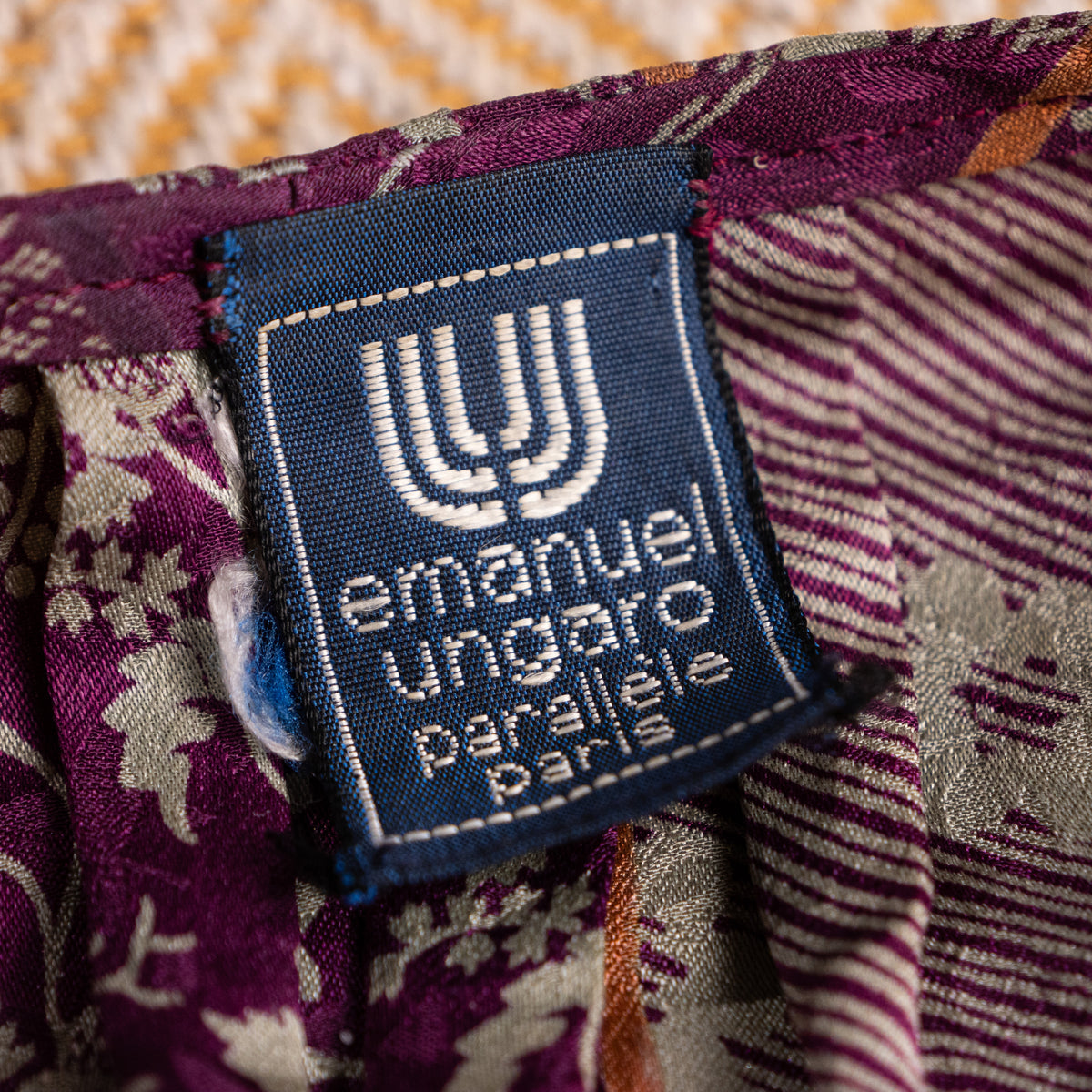 Close-up interior view of the pristine woven navy-blue Emanuel Ungaro Parallèle Paris neck label featuring the signature white double-U logo.
