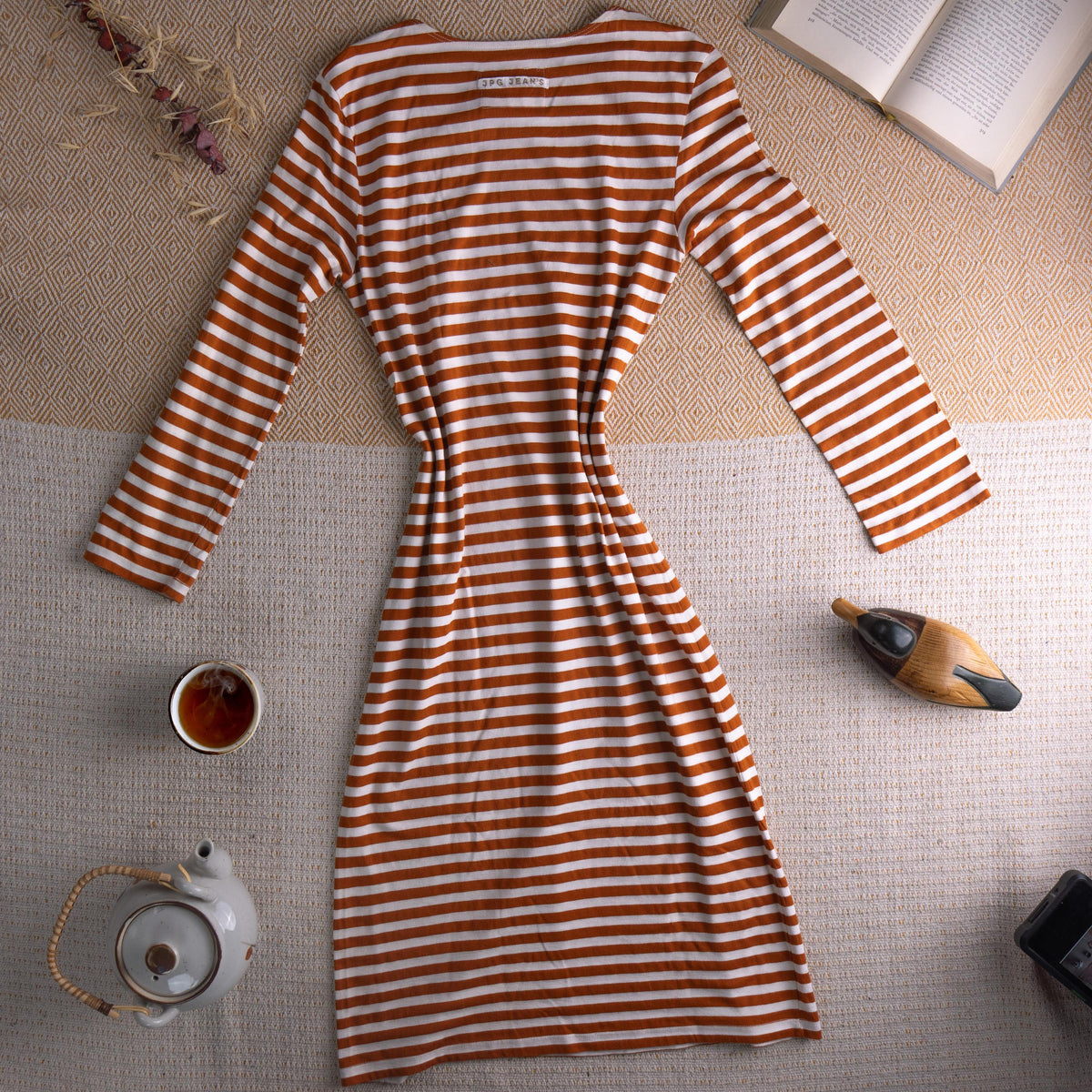 back view Jean Paul Gaultier JPG Jean's Archival 90s Marinière Stripe Midi Dress – rust orange and white horizontal stripe stretch jersey, optical illusion trompe l'oeil ruched bust effect, single chest patch pocket, scoop neckline, long sleeves, body-con midi silhouette, JPG Jean's Collection 0007 woven label, flat lay editorial shot