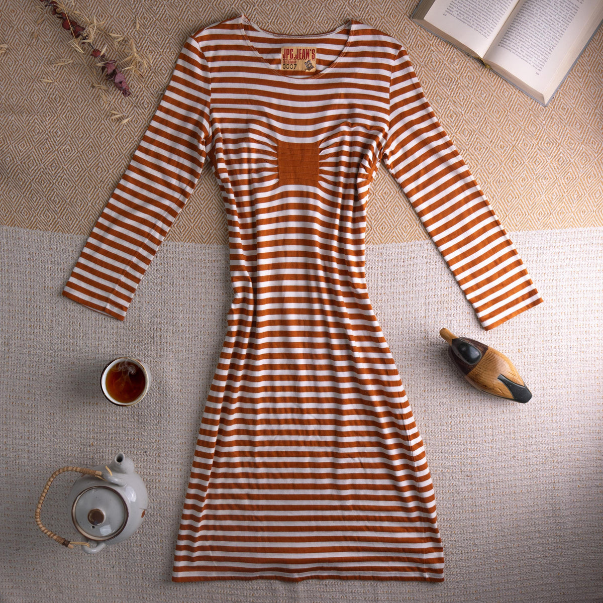 Jean Paul Gaultier JPG Jean's Archival 90s Marinière Stripe Midi Dress – rust orange and white horizontal stripe stretch jersey, optical illusion trompe l'oeil ruched bust effect, single chest patch pocket, scoop neckline, long sleeves, body-con midi silhouette, JPG Jean's Collection 0007 woven label, flat lay editorial shot