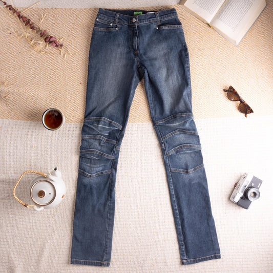 Archival Thierry Mugler Late 1990s Indigo Ribbed Biker Star Jeans – mid-wash indigo stretch denim, low rise with single star button and zip fly, five-pocket construction, triple horizontal ribbed moto panel seaming at both knees, slim straight leg silhouette, hourglass fit, Mugler green label, IT 27 W26-27, flat lay editorial shot