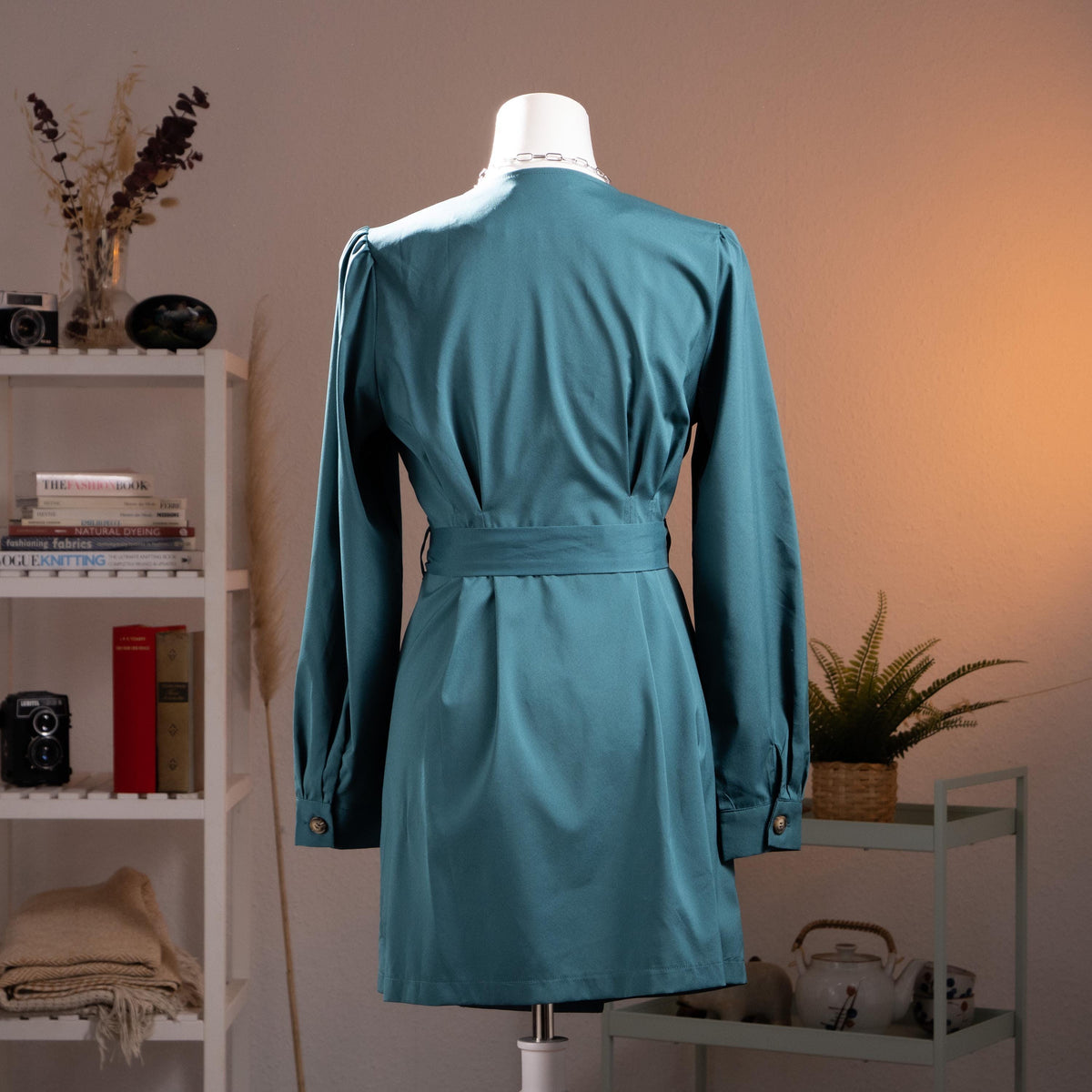 back view Archival Oscar de la Renta NOS Deadstock 90s Trench Mini Dress – petrol teal blue gabardine, wide lapel V-neckline, double-breasted with gold logo buttons, long sleeves with puff shoulder detail, self-tie waist belt, A-line mini silhouette, product shot on dress form