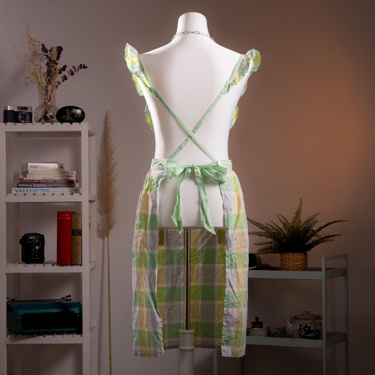 back view Archival Courrèges Paris 80s Japan License Metallic Lurex Gingham Pinafore Dress – oversized pastel check in mint green, butter yellow and white with metallic lurex shimmer, ruffled flutter shoulder straps, square neckline, open-back tabard silhouette with tie waist, two front patch pockets, midi length, rare Japan license piece, product shot on dress form